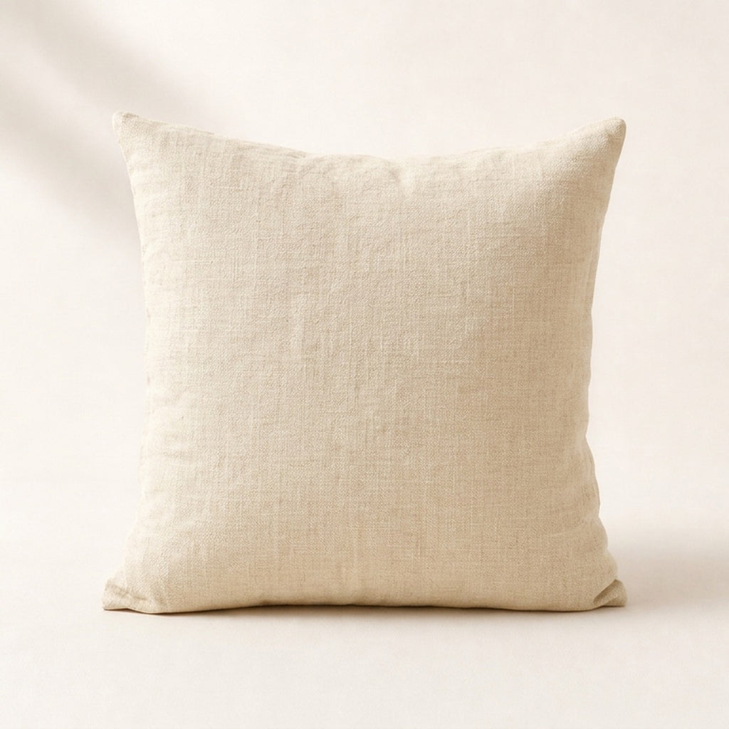 Coussin Buttes-Chaumont en lin lavé coloris écru, de face sur fond crème